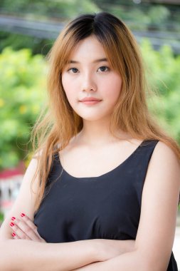 Beautiful young adult thai chinese bronze hair relax and smile