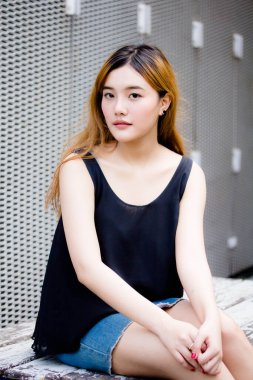 Beautiful young adult thai chinese bronze hair relax and smile