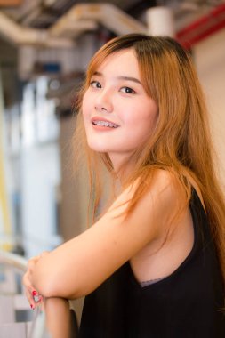 Beautiful young adult thai chinese bronze hair relax and smile
