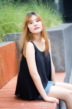 Beautiful young adult thai chinese bronze hair relax and smile