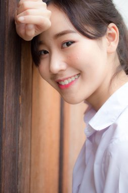 Taylandlı liseli üniformasının portresi. Genç güzel kız mutlu ve rahat.