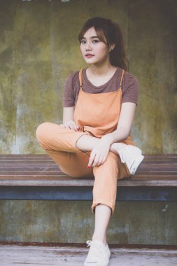 Beautiful young adult thai chinese bronze hair relax and smile