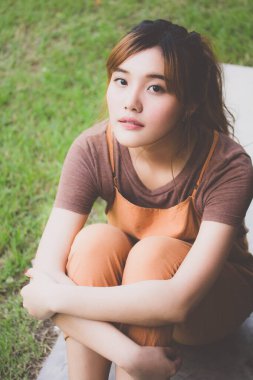 Beautiful young adult thai chinese bronze hair relax and smile