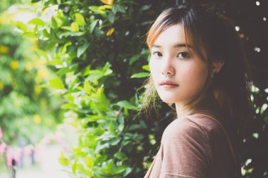 Beautiful young adult thai chinese bronze hair relax and smile