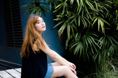 Beautiful young adult thai chinese bronze hair relax and smile