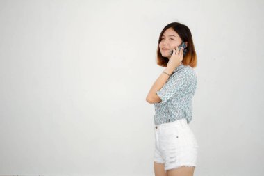 Portrait of thai adult beautiful girl short hair calling smart phone