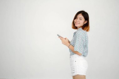 Portrait of thai adult beautiful girl short hair using her smart phone