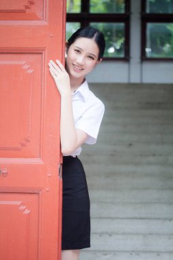 Taylandlı yetişkin öğrenci üniforması portresi. Güzel kız rahatla ve gülümse.