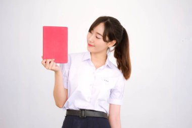 Asya Taylandlı lise öğrencisi üniforması. Güzel kız bir kitap okumuş.