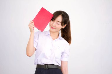 Asya Taylandlı lise öğrencisi üniforması. Güzel kız bir kitap okumuş.