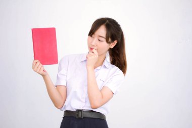 Asya Taylandlı lise öğrencisi üniforması. Güzel kız bir kitap okumuş.