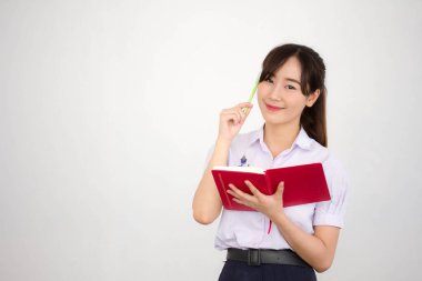 Asya Taylandlı lise öğrencisi üniforması. Güzel kız bir kitap okumuş.