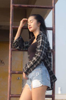 Tayland portresi yetişkin güzel kız siyah gömlek mavi kot pantolon rahatla ve gülümse