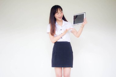 Portrait of thai adult student university uniform beautiful girl show her tablet.