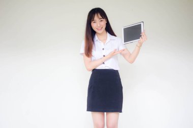 Portrait of thai adult student university uniform beautiful girl show her tablet.
