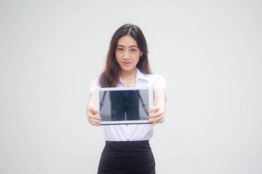 Portrait of thai adult student university uniform beautiful girl show her tablet.