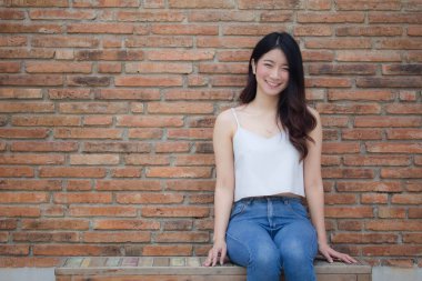 Tayland portresi yetişkin güzel kız beyaz gömlek mavi kot rahatla ve gülümse