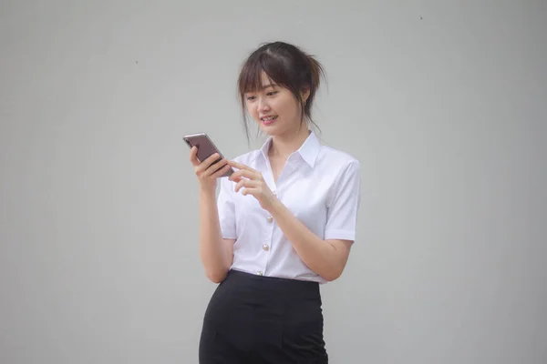 彼女のスマートフォンを使用してタイの大人学生の大学制服美少女の肖像画 — ストック写真
