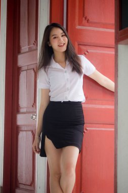 Taylandlı yetişkin öğrenci üniforması güzel kız rahatla ve gülümse.