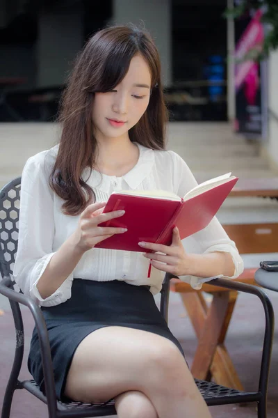 portrait of thai china adult office girl white shirt reading red book