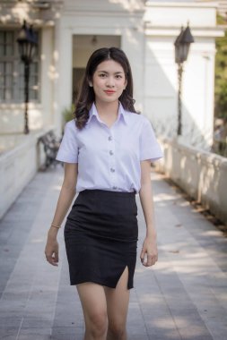 Taylandlı yetişkin öğrenci üniforması güzel kız rahatla ve gülümse.