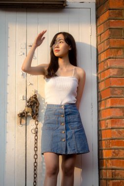 Tayland portresi yetişkin güzel kız beyaz gömlek mavi kot rahatla ve gülümse