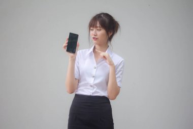 Taylandlı yetişkin üniversite üniforması güzel kız akıllı telefonunu göster.