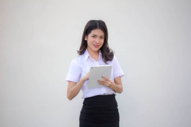 Yetişkin öğrenci üniforması. Tabletini kullanan güzel bir kız.