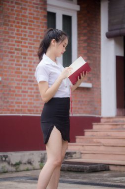 Taylandlı yetişkin öğrenci üniforması güzel kız rahatla ve gülümse.