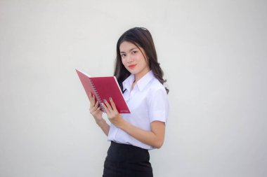 Taylandlı yetişkin üniversite üniforması güzel kız kırmızı kitabı okuyor.