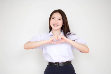 Taylandlı liseli üniformasının portresi. Güzel bir kız kalbini verir.