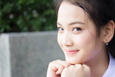 Taylandlı liseli üniformasının portresi. Genç güzel kız mutlu ve rahat.