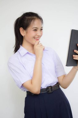 Portrait of thai high school student uniform beautiful girl using her tablet