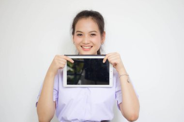 Portrait of thai high school student uniform beautiful girl using her tablet