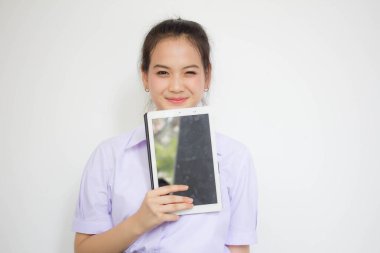 Portrait of thai high school student uniform beautiful girl using her tablet