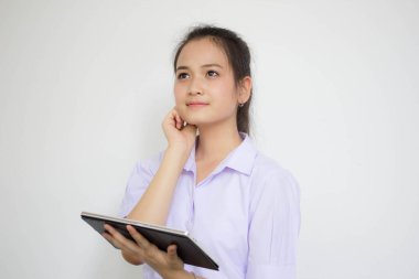 Portrait of thai high school student uniform beautiful girl using her tablet