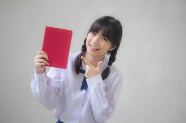 Asya Thai lisesi üniforması güzel kız bir kitap göster