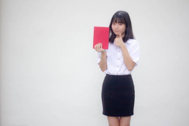 Taylandlı yetişkin öğrenci üniforması güzel kız kırmızı kitap gösteriyor.