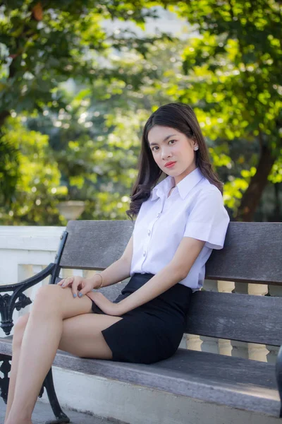 Taylandlı yetişkin öğrenci üniforması güzel kız rahatla ve gülümse.