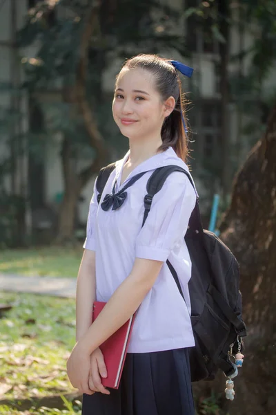 Asya Thai ortaokulu öğrencisi üniforması güzel kız gülümse ve rahatla
