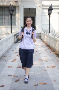 Asya Thai ortaokulu öğrencisi üniforması güzel kız gülümse ve rahatla