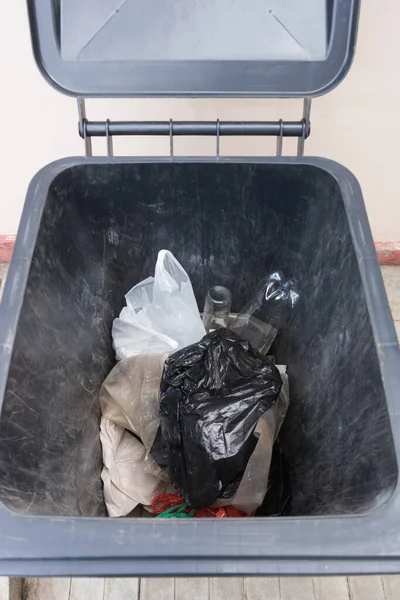 household trash inside an open trash can