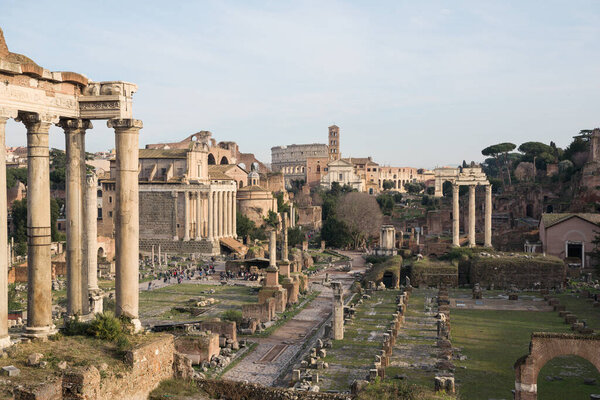 Cityscape of the Roman Forum ruins with the Arch of Severus, temple of Saturn, temple of Vesta, Basilica of Maxentius, Arch of Titus and Colosseum in Rome, Italy
