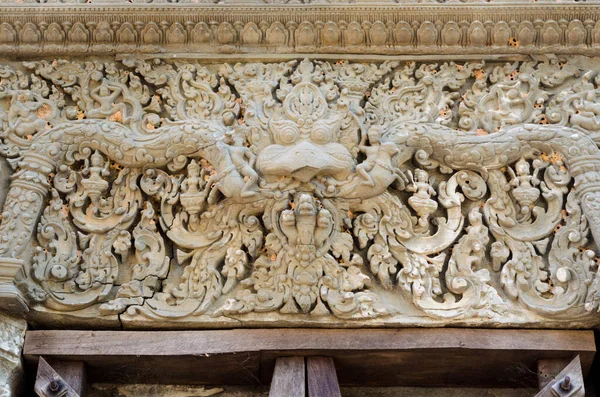 Garuda head and demon carvings on a lintel in Lolei ancient Hindu temple, Angkor Wat, Siem Reap, Cambodia