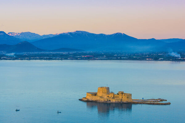 The Venetian Bourtzi fortress in Nafplio Bay, with sea and mountains in the background, in Peloponnese, Greece