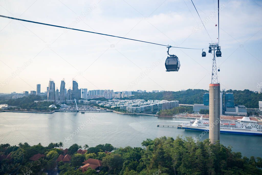 Singapore - 4 Sep 2019: a cable car passes over Sentosa island, with views on Faber Hill, VivoCity, the Marina and the port in Singapore.