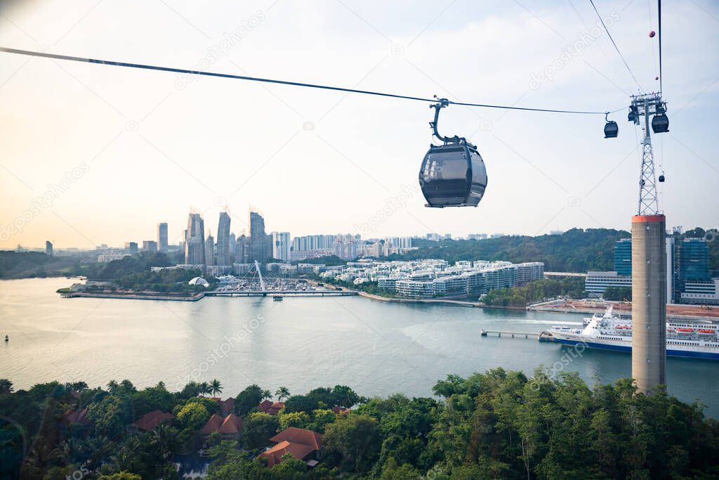 Singapore-4 Sep 2019: a cable car passes over Sentosa island, with views on Faber Hill, VivoCity, the Marina and the port in Singapore.