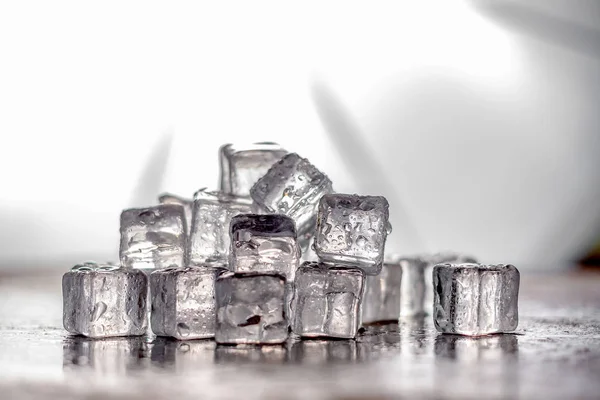Pile of Ice cubes on dark wooden table