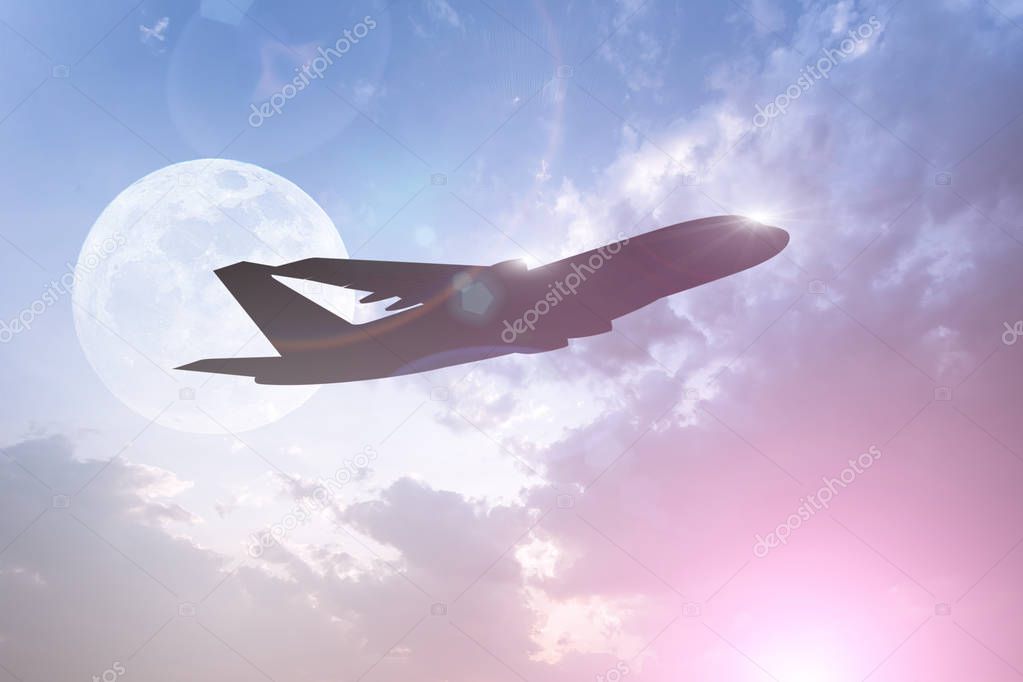 Silhouette of Airplane on colorful dramatic sky with clouds