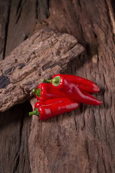 Red chilly pepper on wooden black background. Red hot chili pepp